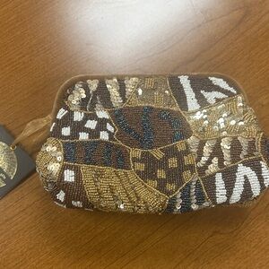 From India to you brown and gold beaded clutch with silver crossbody.